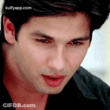 A Close Up Of A Man 'S Face With His Mouth Open And His Tongue Sticking Out . GIF