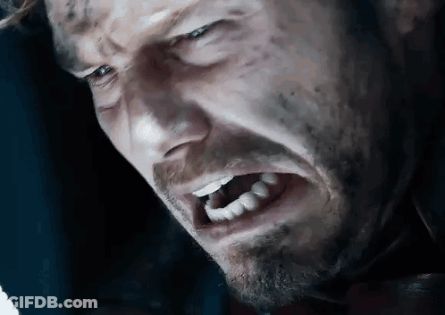 A Close Up Of A Man 'S Face With His Mouth Open And Teeth Showing . GIF