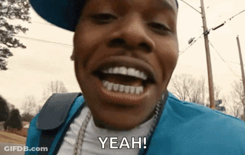 A Close Up Of A Man 'S Face With His Mouth Open And The Words `` Yeah '' . GIF