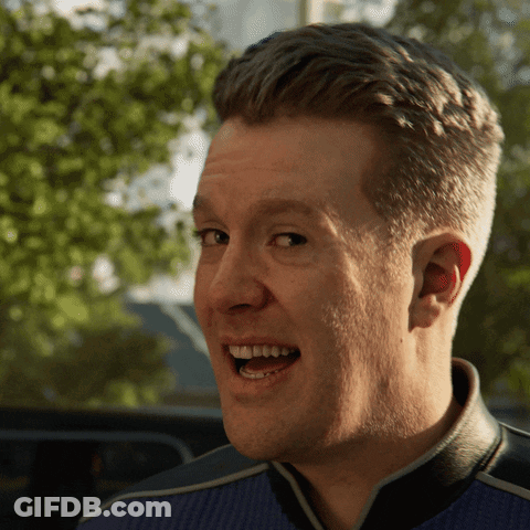 A Close Up Of A Man 'S Face With His Mouth Open And Trees In The Background GIF