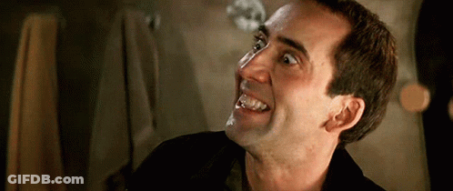 A Close Up Of A Man 'S Face With His Mouth Open GIF