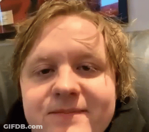 A Close Up Of A Man 'S Face With His Mouth Open GIF