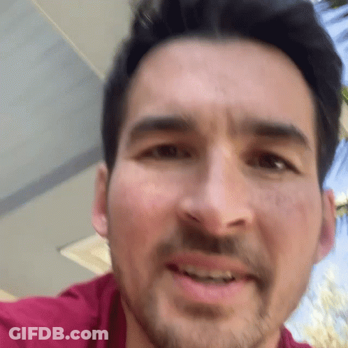 A Close Up Of A Man 'S Face With His Mouth Open GIF