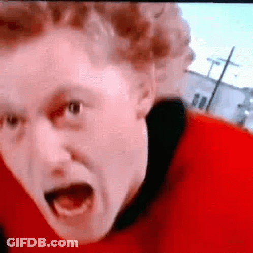 A Close Up Of A Man 'S Face With His Mouth Wide Open GIF