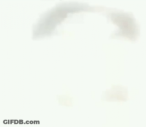 A Close Up Of A Man 'S Face With His Tongue Hanging Out . GIF