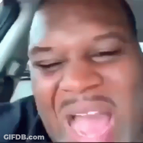 A Close Up Of A Man 'S Face With His Tongue Hanging Out . GIF