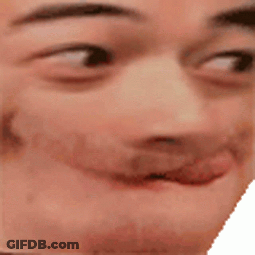 A Close Up Of A Man 'S Face With His Tongue Out And A Smile On His Face . GIF
