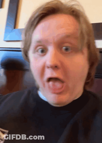 A Close Up Of A Man 'S Face With His Tongue Out GIF