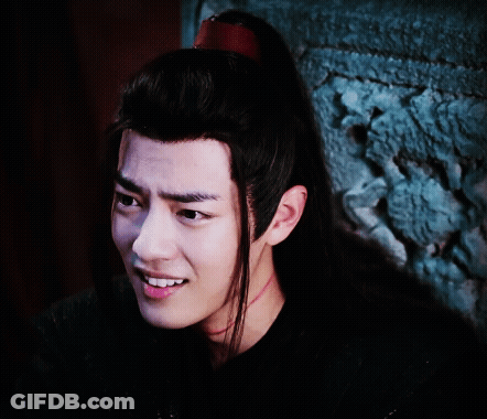 A Close Up Of A Man 'S Face With Long Black Hair GIF