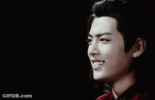 A Close Up Of A Man 'S Face With Long Hair GIF