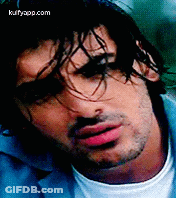 A Close Up Of A Man 'S Face With Long Hair And A Beard . GIF