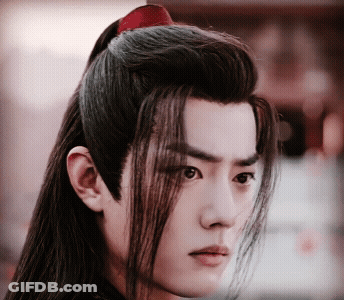 A Close Up Of A Man 'S Face With Long Hair And A Ponytail GIF