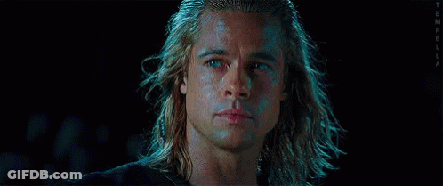 A Close Up Of A Man 'S Face With Long Hair And Blue Eyes . GIF