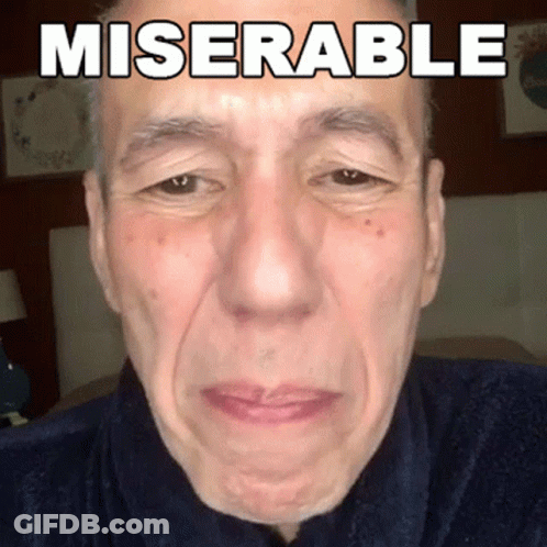 A Close Up Of A Man 'S Face With Miserable Written On His Face GIF