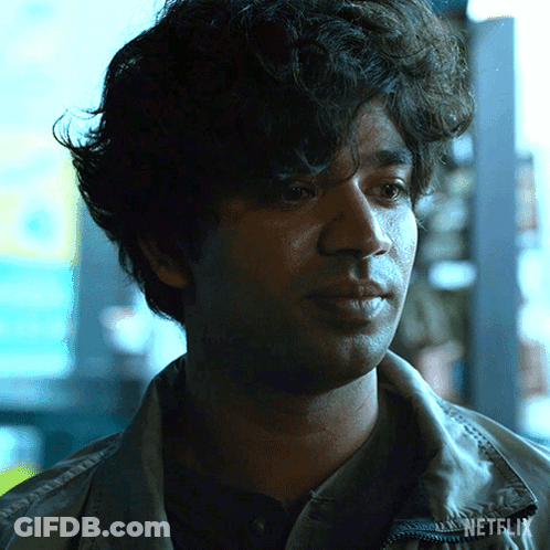 A Close Up Of A Man 'S Face With Netflix Written On His Jacket GIF