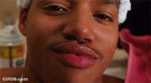 A Close Up Of A Man 'S Face With Pink Lipstick On His Lips . GIF
