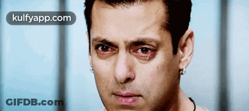 A Close Up Of A Man 'S Face With Red Eyes And The Words Kulfyapp.com Below Him GIF