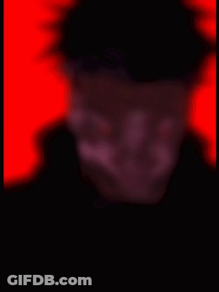 A Close Up Of A Man 'S Face With Red Eyes On A Red Background . GIF