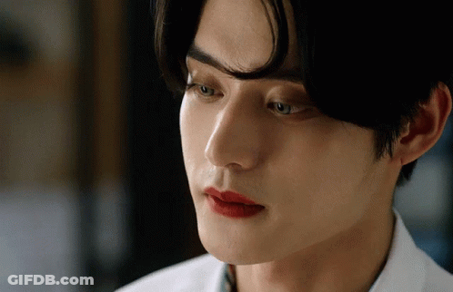 A Close Up Of A Man 'S Face With Red Lips GIF