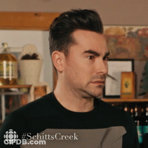 A Close Up Of A Man 'S Face With #Schitts Creek Written On The Bottom Right GIF
