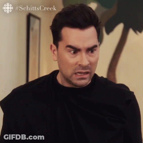 A Close Up Of A Man 'S Face With #Schitts Creek Written On The Bottom Right GIF