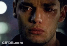 A Close Up Of A Man 'S Face With Tears Coming Out Of His Eyes . GIF