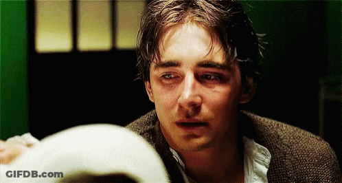 A Close Up Of A Man 'S Face With Tears Coming Out Of His Eyes . GIF