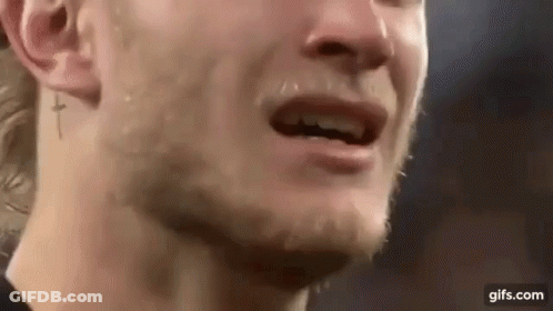 A Close Up Of A Man 'S Face With Tears Running Down His Face And A Cross Tattoo On His Ear . GIF