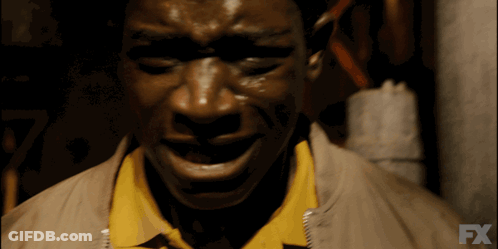 A Close Up Of A Man 'S Face With The Fx Logo In The Background GIF