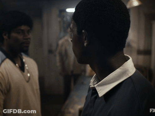 A Close Up Of A Man 'S Face With The Fx Logo In The Background GIF