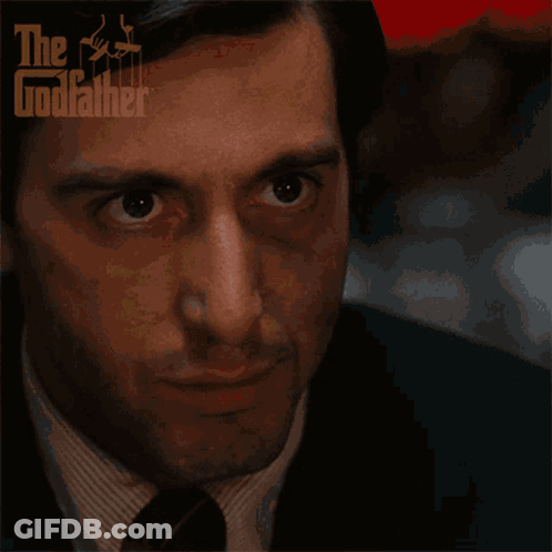 A Close Up Of A Man 'S Face With The Godfather Logo On The Bottom GIF