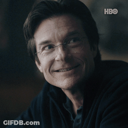 A Close Up Of A Man 'S Face With The Hbo Logo Behind Him GIF