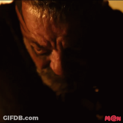 A Close Up Of A Man 'S Face With The Letter M On The Bottom Right Corner GIF