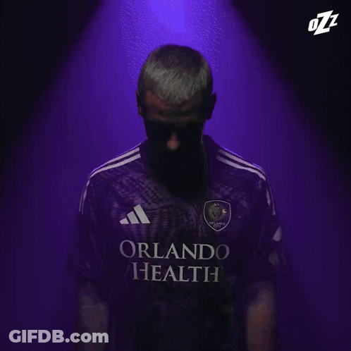 A Close Up Of A Man 'S Face With The Letters Ozz On His Head GIF