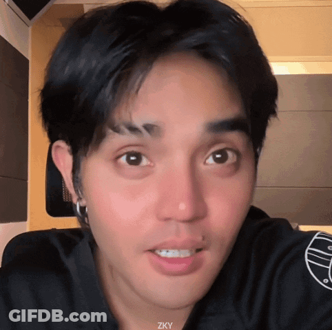 A Close Up Of A Man 'S Face With The Letters Zky Visible GIF