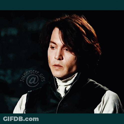 A Close Up Of A Man 'S Face With The Name Johnny Depp At The Bottom Of The Image GIF