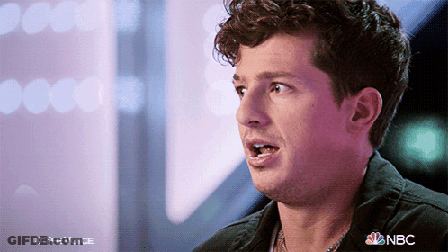 A Close Up Of A Man 'S Face With The Nbc Logo In The Background GIF