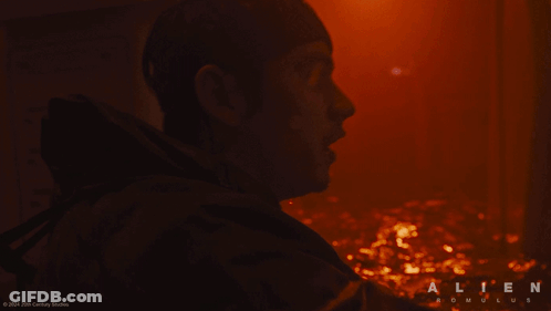 A Close Up Of A Man 'S Face With The Word Alien On The Bottom Right GIF