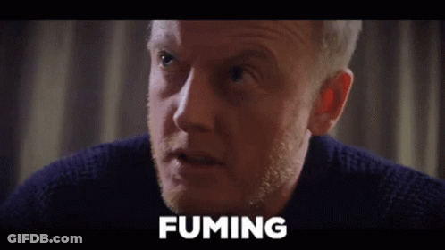 A Close Up Of A Man 'S Face With The Word Fuming Written Above Him GIF