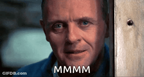 A Close Up Of A Man 'S Face With The Word Mmmm Written On It GIF