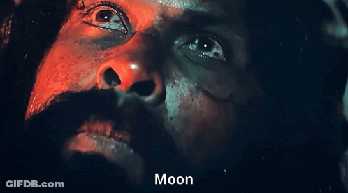 A Close Up Of A Man 'S Face With The Word Moon On The Bottom Right GIF