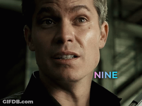 A Close Up Of A Man 'S Face With The Word Nine In Blue Letters GIF