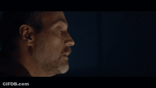 A Close Up Of A Man 'S Face With The Word Request Behind Him GIF