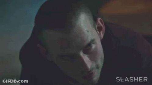 A Close Up Of A Man 'S Face With The Word Slasher On The Bottom Right GIF
