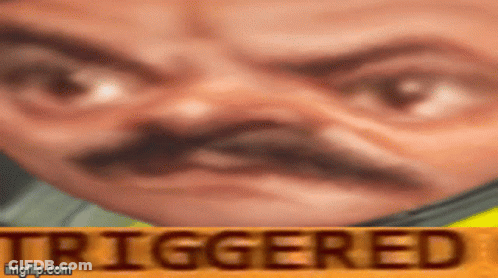 A Close Up Of A Man 'S Face With The Word Triggered In The Corner . GIF