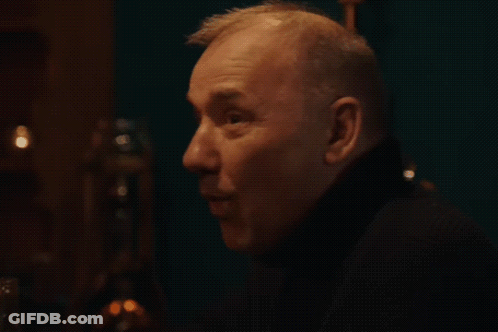 A Close Up Of A Man 'S Face With The Word Whoa Written In White GIF