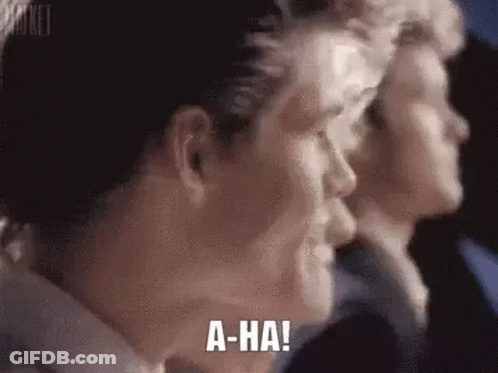 A Close Up Of A Man 'S Face With The Words `` A-Ha '' Written On His Face . GIF