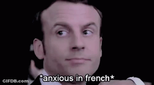 A Close Up Of A Man 'S Face With The Words `` Anxious In French '' Written Below It . GIF