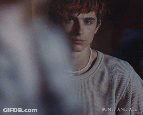 A Close Up Of A Man 'S Face With The Words Bones And All On The Bottom Right GIF