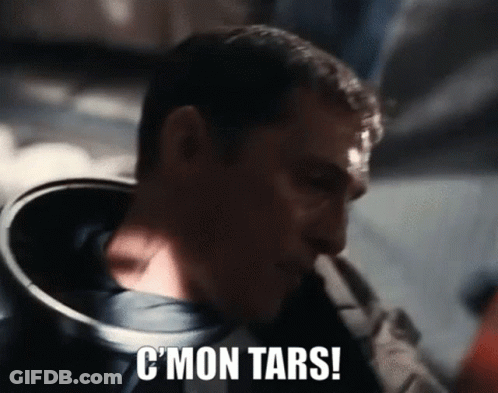 A Close Up Of A Man 'S Face With The Words C ' Mon Tars Written On It . GIF